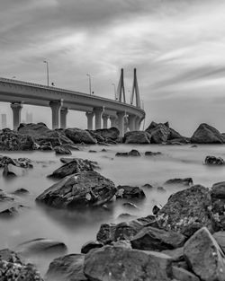 Bridge over sea against sky