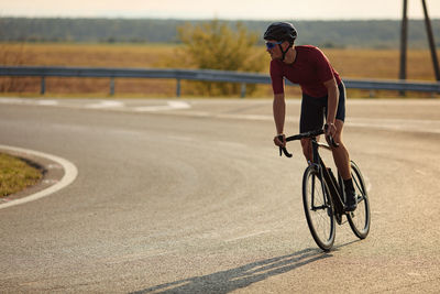 Man riding bicycle on road