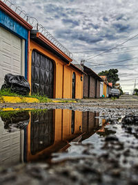 Reflection of building on puddle in lake