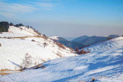 Scenic view of snow covered mountains against sky