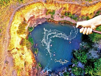 High angle view of hands over sea