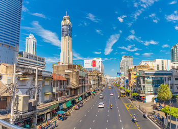 View of city street and buildings against sky