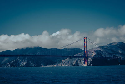 Golden gate suspension bridge over sea against sky