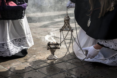 Low section of priest burning incense