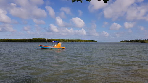 Boat sailing in sea against sky