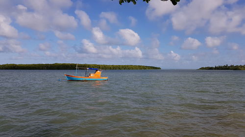 Boat sailing in sea against sky