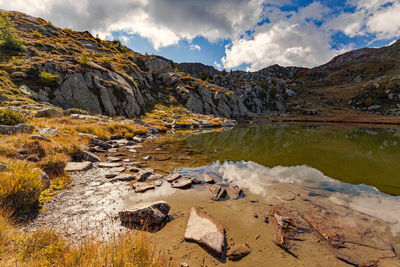 Scenic view of rocks in mountains against sky