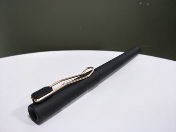 High angle view of pen on table against black background