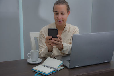 Mid adult woman using laptop on table