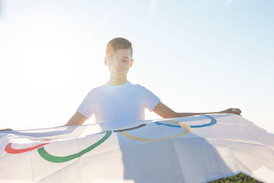 Full length of boy standing against sky