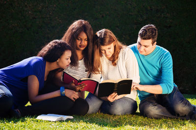 Young couple sitting on book