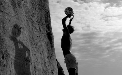 Low angle view of man standing against sky