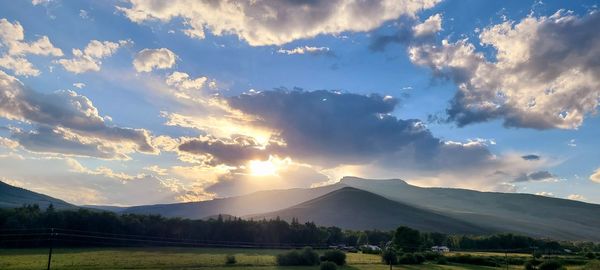 Scenic view of field against sky during sunset