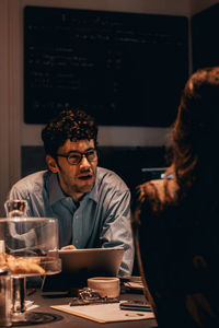 Woman sitting on table at restaurant