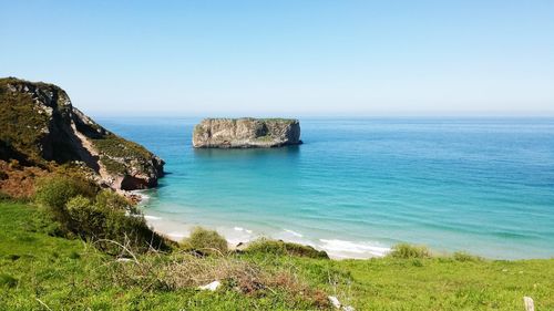 Scenic view of sea against clear blue sky