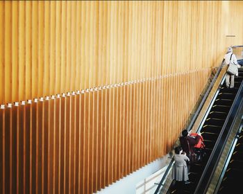 High angle view of people on escalator in shopping mall