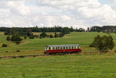 Train on field against sky