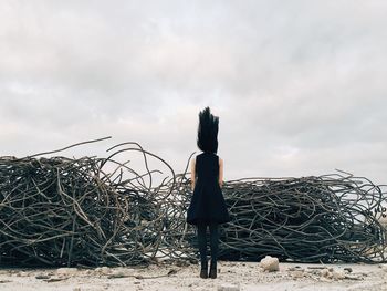 Silhouette of woman against cloudy sky