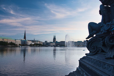 Statue of river with city in background