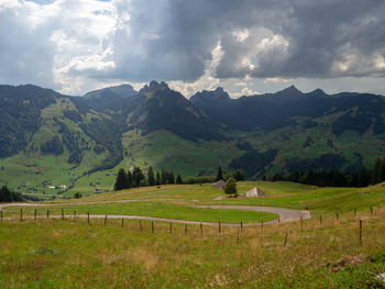 Scenic view of landscape and mountains against sky