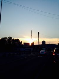 Cars on road at sunset