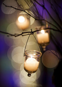 Low angle view of illuminated light bulbs hanging from ceiling