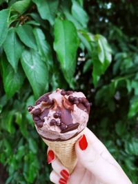 Close-up of hand holding ice cream cone