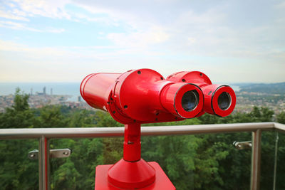 Close-up of coin-operated binoculars against sky