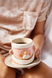 Cropped woman drinking tea. cozy winter time background.