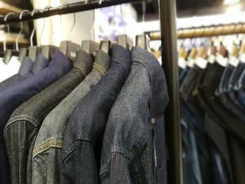 Close-up of clothes hanging in rack