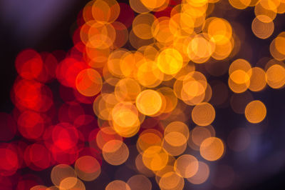 Defocused image of illuminated christmas lights at night