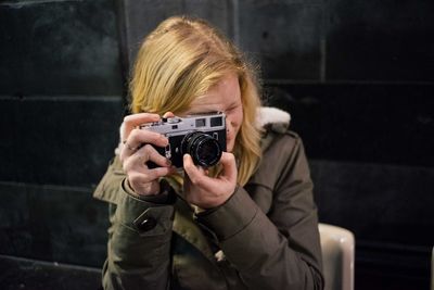 Young woman photographing with camera