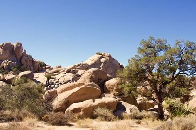 Scenic view of rocks against clear sky