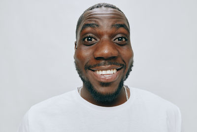 Portrait of young man against white background