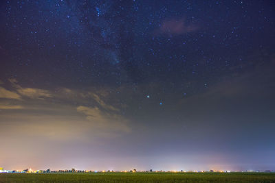 Scenic view of field against sky at night