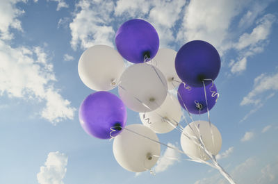 Low angle view of balloons against sky