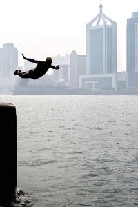 Woman jumping in water