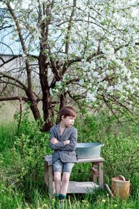 Woman sitting on bench in park