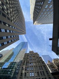 Directly below shot of modern buildings kin city against sky