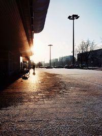 Man on road in city against clear sky