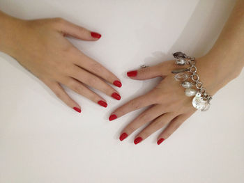 Cropped hands of woman with red nail polish