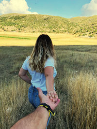 Rear view of woman on field