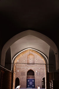 Woman in historic building at night