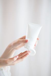 Close-up of woman hand holding white background