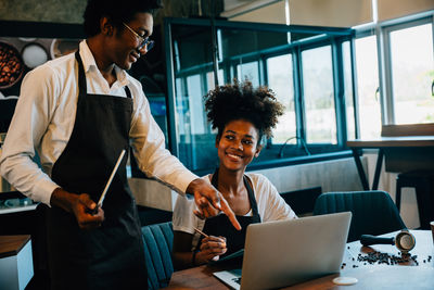 Businesswoman using laptop while sitting in cafe