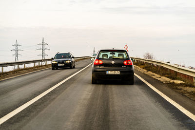 Cars on road against sky