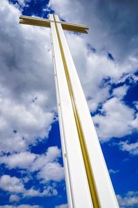 Low angle view of crane against blue sky