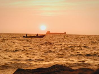 Scenic view of sea against orange sky