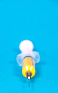 Close-up of light bulb against blue background