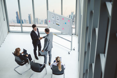 High angle view of businesspeople in board room during meeting